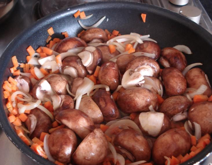 1. Этап. Пирог с грибами и сыром стилтон: 1. Нарезать лук. Порубить морковь. Промыть и почистить грибы, разрезать на две половинки. Покрошить сыр стилтон. Разогреть духовку до 200 градусов. Смешать муку, сливочное масло и яйцо вместе, заместить тесто. Добавить несколько капель молока. Скатить тесто в мячик, завернуть в пищевую пленку и поставить в холодильник на 30 минут. Разогреть растительное масло в сковородке, добавить лук, морковь и грибы и жарить 3-4 минуты, пока ингредиенты не станут мягкими.