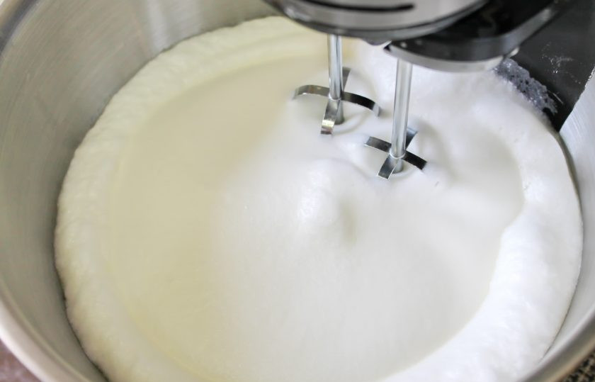 1. Этап. Меренговый рулет с клюквой: Белки перелейте в чистую чашу миксера и добавьте щепотку соли. Взбивайте белки на средней скорости до мягких пиков.