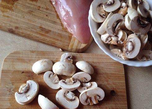 1. Этап. Курица в сливочном соусе с грибами: Грибы нарезаем пластинками и отправляем на разогретую сковороду с двумя ложками растительного масла.