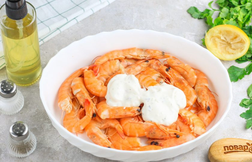 1. Этап. Креветки в аэрофритюрнице: Креветки промойте в воде, подсушите бумажными салфетками и выложите в глубокую емкость. Выложите сметану любой жирности. Можно вместо нее использовать любой соус на белой основе, например — чесночный.