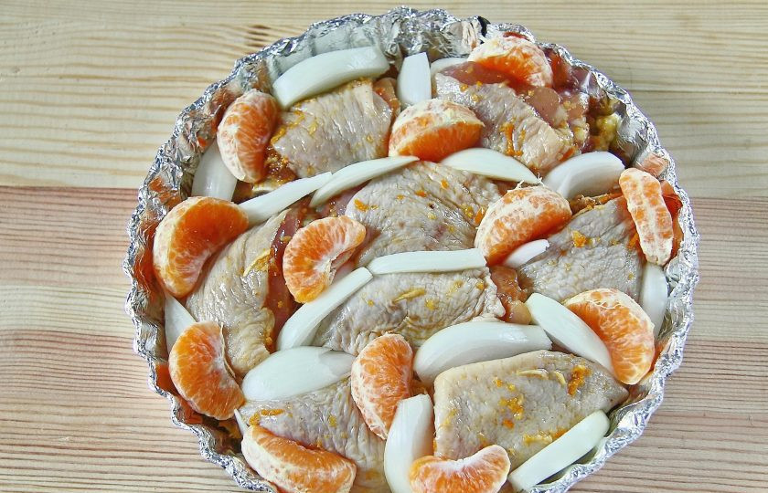 1. Этап. Курица в мандаринах: Добавьте дольки оставшихся мандаринов и нарезанный крупно лук.