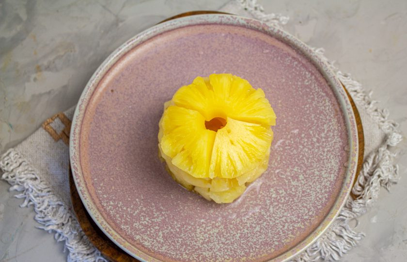 1. Этап. Салат Ананасовое кольцо: На середину плоской тарелки выложите 4-5 колечек ананаса и каждое из них разрежьте до низа по кругу на 4 части.