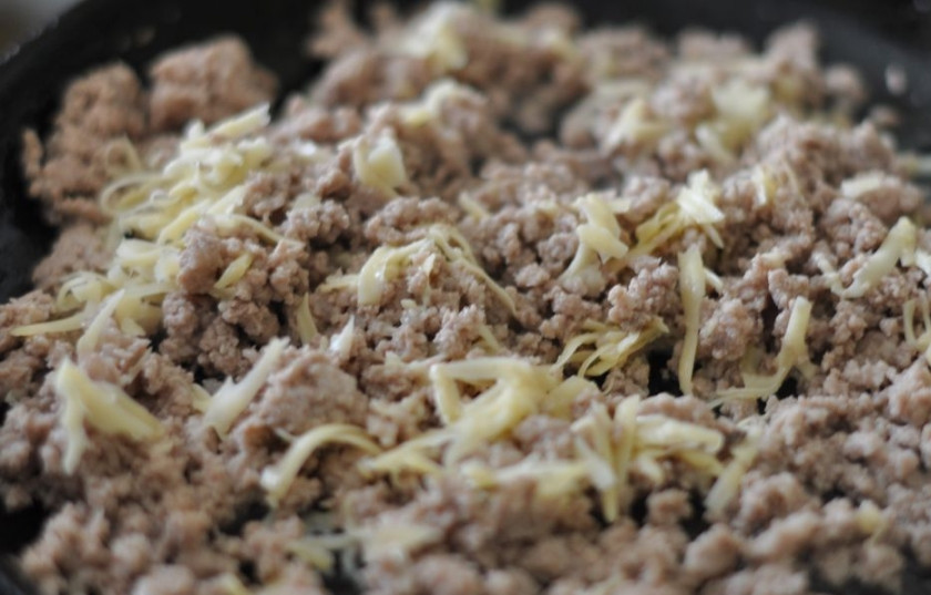 1. Этап. Макароны фаршированные в духовке: Обжарьте фарш на масле, посолите и поперчите. Натрите половину сыра и добавьте в остывший фарш.