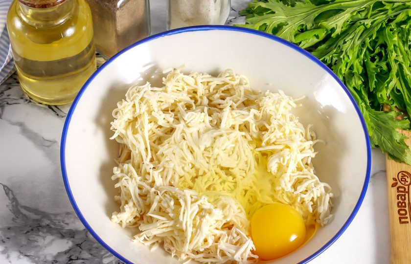 1. Этап. Сырники из плавленых сырков: Вбейте в тарелку куриное яйцо, всыпьте щепотку соли и тщательно все перемешайте вилкой, слегка прижимая.