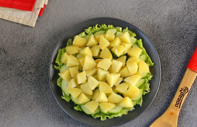 1. Этап. Диетический салат с консервированным тунцом: Картофель очистите, нарежьте кубиками и выложите следующим слоем.