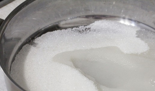 1. Этап. Мандарины в коньячном сиропе: В сотейник всыпать сахар и влить воду. Поставить его на огонь.