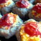 Котлетки на баклажанах под сырной шапкой Прокрутить мясо, лук, замоченный в воде и отжатый ломтик батона. Посолить, поперчить, вбить яйцо. Вымешать фарш, поставить в холодильник на время приготовления начинки. Баклажаны нарезать шайбочками, толщиной 0,5 см, посолить, через 10 мин промыть под проточной водой, осушить полотенцем, пожарить на раст. масле с одной стороны. Измельчить грибы, прожарить 7 мин. в небольшом кол-ве раст. масла. В конце жарки добавить чайн. лож. сливочного масла для усиления аромата грибов. Плавленный сырок размять вилкой, вбить яйцо. Разрезать помидор пополам, потереть на терке, отделившуюся шкурку выкинуть, слить жидкость. Мякоть помидора и измельченный ножом зубок чеснока добавить к плавленному сырку, посолить, перемешать. Выбранную форму для запекания (у меня 23 на 33 см) смазать раст. маслом, посыпать солью и перцем. Разложить в один слой баклажаны, жаренной стороной кверху. Скатать круглые шарики, размером с небольшую тефтелю (1 стол. лож. фарша), обвалять в сухарях, расплющить. Выдавить ямку-гнездышко, выкладываем по котлетке на каждый кружок баклажана. Заполнить углубления грибами. На грибы-сырно-томатную начинку С помидорок черри срезать бочки и украсить котлетки. (С одного помидорчика можно получить 2-3 кругляшка). Завершающий штрих: сбрызнуть котлетки оливковым маслом и посыпать прованскими травами. В духовку на 45 мин. при t 180. Подаем горячими Приятного аппетита!