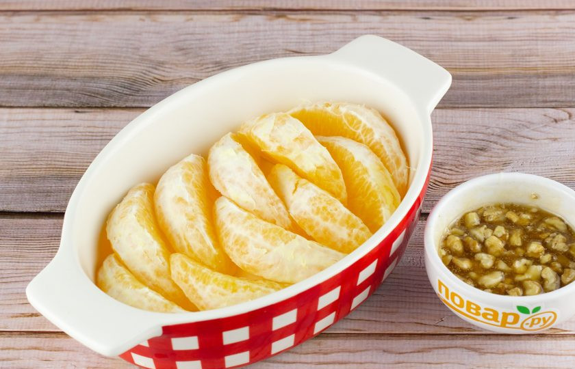 1. Этап. Апельсин в духовке с медом и корицей: Апельсины очистите от шкурки и белых пленок, разделите на дольки. Выложите дольки в форму для запекания. Орехи немного порубите. Мед перемешайте с корицей и орехами.