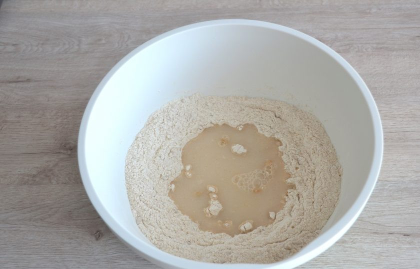 1. Этап. Голландский хлеб: Сделайте в муке углубление, влейте дрожжевую смесь.