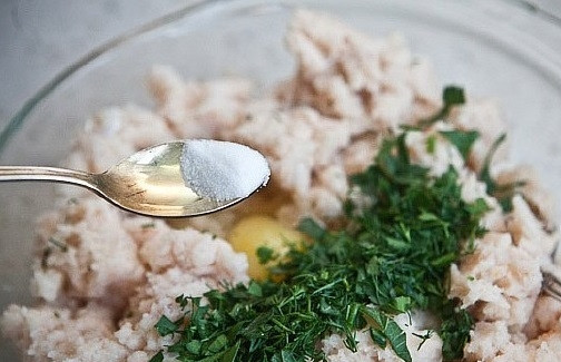 1. Этап. Рыбные котлеты из трески: К фаршу добавьте измельчённую и промытую петрушку, соль, яйцо и перец. Всё перемешайте.