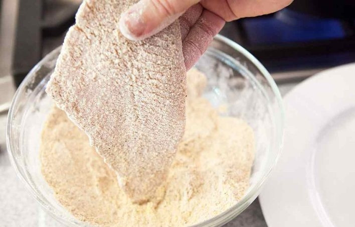 1. Этап. Жареная зубатка: 2. Разогрейте сковороду с растительным маслом. Смешайте пшеничную и кукурузную муку, добавьте соль, чесночный порошок, паприку и кайенский перец. Каждый кусочек рыбы обмакните в панировке с двух сторон.