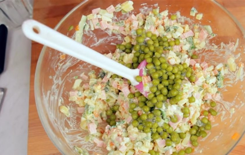 1. Этап. Новогодний венок из оливье: 2. Добавьте горошек, посолите, поперчите и заправьте майонезом. Хорошо перемешайте.