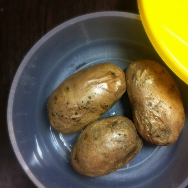 1. Stage. Potatoes under cheese in the microwave: The readiness of potatoes is determined by their appearance. It should be slightly dry and with wrinkled skin. Peel the potatoes and cut in half.