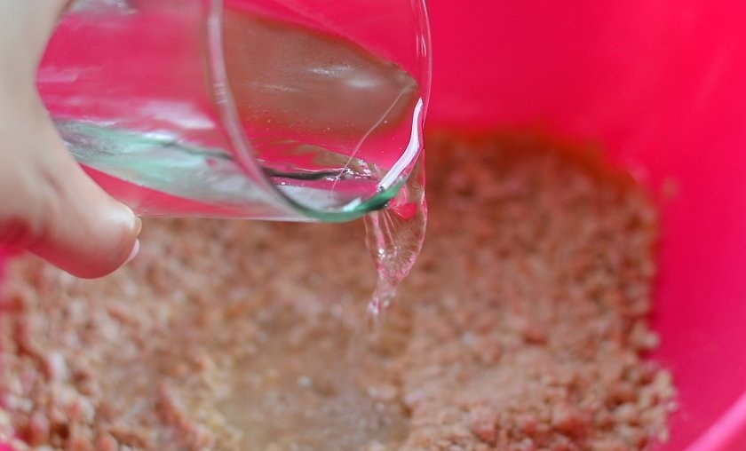 1. Этап. Овсяные блинчики: 5. Влейте в миску очищенную холодную воду и еще раз все перемешайте. Оставьте массу на 5-7 минут.