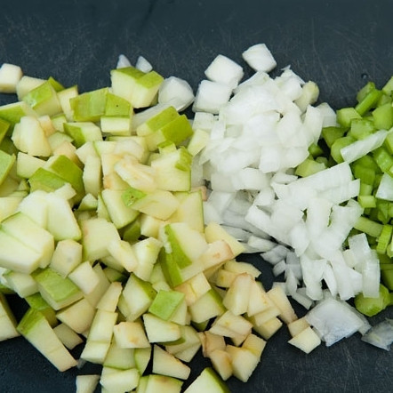 1. Этап. Салат из курицы с сельдереем: 2. Пока курица тушиться, приготовьте овощи. Луковицу очистите и нарежьте мелкими кубиками, сельдерей измельчите. Яблоко очистите от семян и также измельчите.