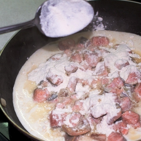 1. Этап. Жульен из горбуши: Еще спустя 3-4 минуты добавляем в сковороду муку. Быстро перемешиваем, чтобы мука не успела свернуться крупными комочками.