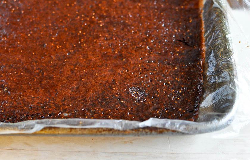 1. Этап. Домашняя фруктовая карамель: 4. Через 6-8 часов поместить аккуратно снять фруктовую массу с противня, убрать полиэтиленовую пленку, заменить ее бумагой для выпекания и выложить фруктовую массу обратно. Поместить в духовку или на солнце еще на 6-8 часов. Если она становится слишком сухой, смазать карамель смоченной в воде кистью.