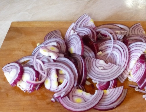 1. Этап. Гусь в казане: Чистим и моем лук, нарезаем его полукольцами.