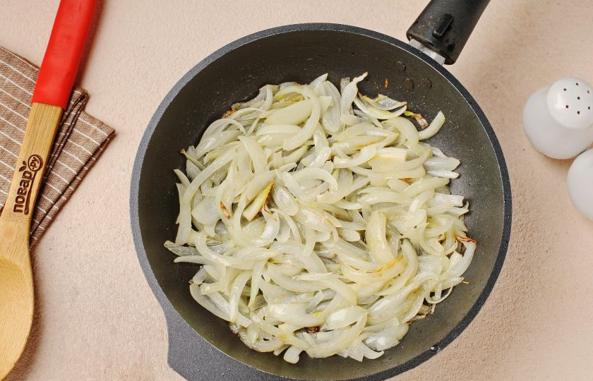 1. Этап. Куриные бёдра в сметанном соусе в духовке: В разогретой сковороде с маслом обжарьте нарезанный перьями лук.