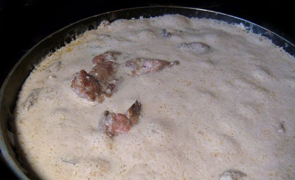 1. Этап. Куриная печенка: Далее в сковороду добавьте сметану, разведённую с водой. Также всыпьте соль и сахар для соуса. Доведите блюдо до кипения. Потом поставьте его под крышку на небольшой огонь.