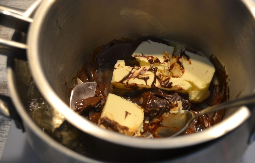 1. Этап. Брауни с малиной: Вмешайте в шоколад сливочное масло.