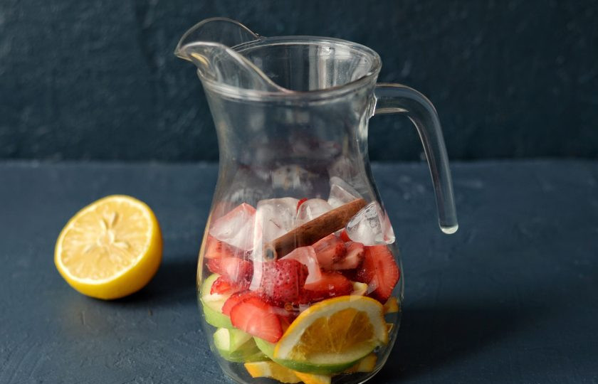 1. Этап. Безалкогольная Сангрия: Из лимона выжмите сок. Добавьте в кувшин палочку корицы, сироп и лёд.