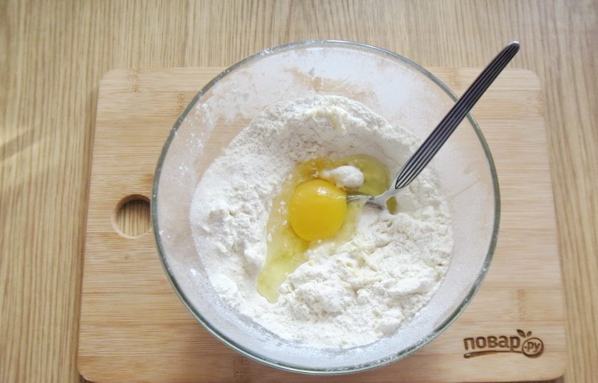 1. Этап. Сочники с вишней: Масло перемешайте с мукой и добавьте яйцо.