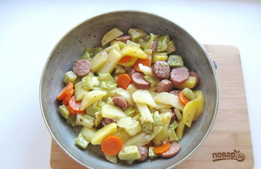 1. Этап. Картофель с колбасками в духовке: Выложите овощи с колбасками на противень или в глубокую сковороду. Отправьте в духовку, разогретую до 190-200 градусов и запекайте до готовности 35-40 минут.