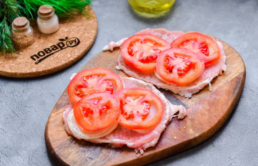 1. Этап. Мясо по-французски с горчичным соусом: Помидоры нарежьте пластинами, выложите поверх лука.