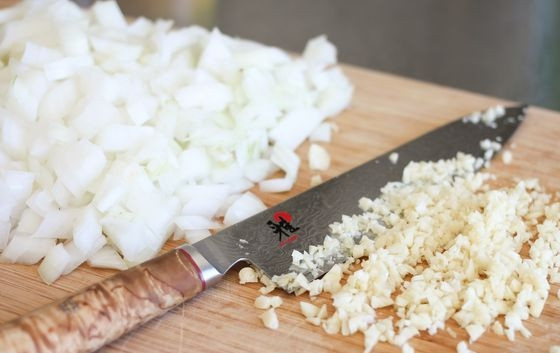 1. Этап. Вкусная лазанья: Мелко нарежьте лук и измельчите чеснок.