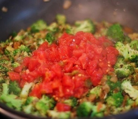 1. Stage. Rice with broccoli and chicken: Disassemble broccoli into inflorescences and put it together with onions in a pan where meat was cooked. Fry occasionally stirring for about 10 minutes, then add the garlic passed through the press, chopped tomatoes and cook for a minute.