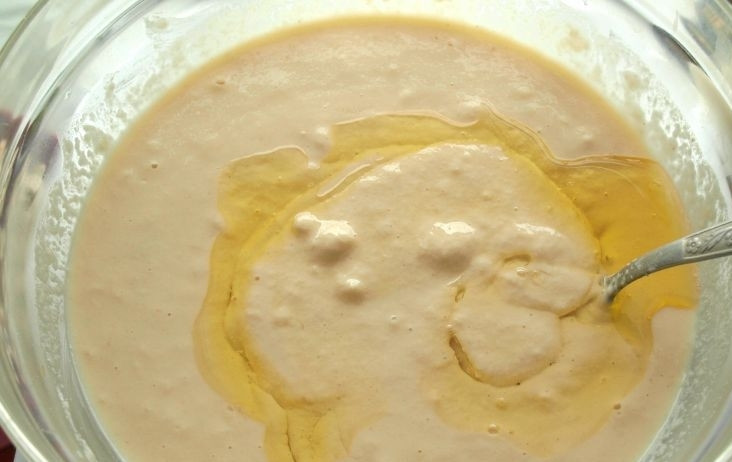 1. Этап. Блины на кефире дрожжевые: В тесто добавляем масло подсолнечное и теплую воду, перемешиваем.