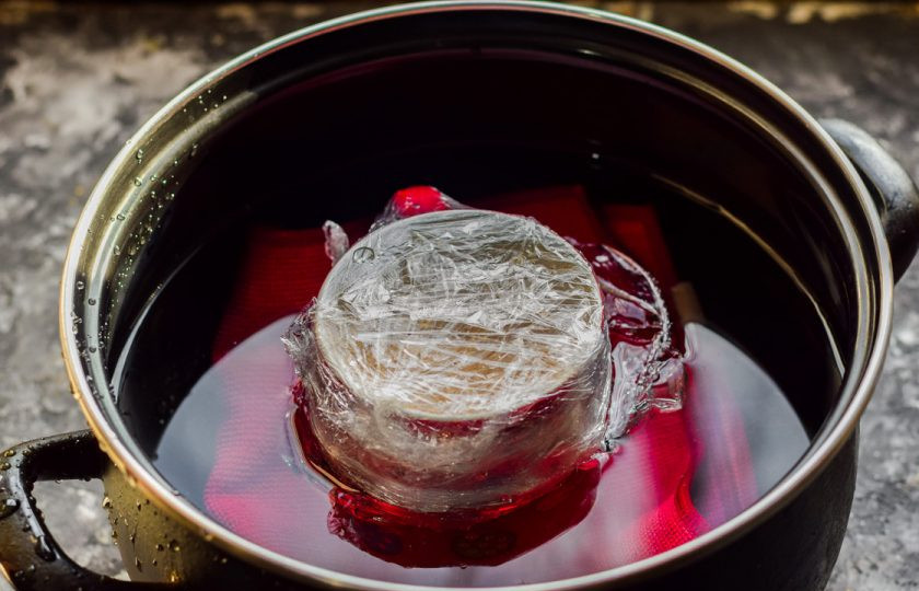 1. Этап. Домашняя колбаса для детей: Кружку запечатайте пленкой. Возьмите кастрюлю, застелите дно тканью, поставьте кружку, и влейте холодную воду. Доведите воду до кипения, готовьте колбасу 35 минут под крышкой на небольшом огне. После остудите колбасу и подавайте к столу.