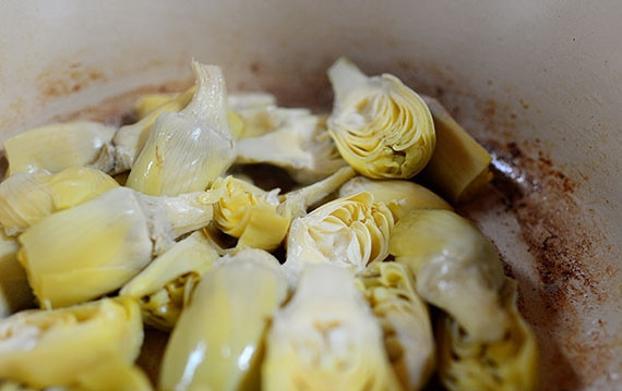 1. Этап. Паста со шпинатом и артишоками: В той же сковороде растапливаем еще немножко масла, теперь бросаем в него разрезанные пополам артишоки. Готовим 2-3 минуты, помешивая, на среднем огне.