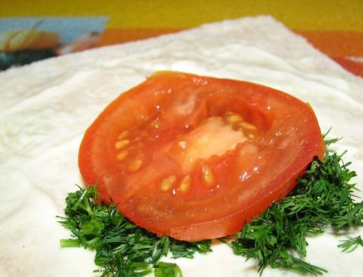 1. Этап. Лаваш с брынзой: Каждую часть лаваша смазываем майонезом. Выкладываем по центру вымытую и нарезанную зелень и кружочек помидора.