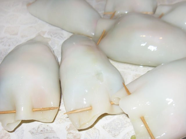 1. Этап. Кальмары, фаршированные овощами: 4. С помощью зубочисток или палочек для шашлычка закрепите края так, чтобы начинка не выпадала в процессе приготовления.