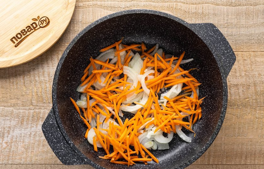 1. Этап. Суп из замороженных грибов: Морковь натрите на терке, а лук нарежьте полукольцами. Обжарьте овощи в растительном масле 2-3 минуты.