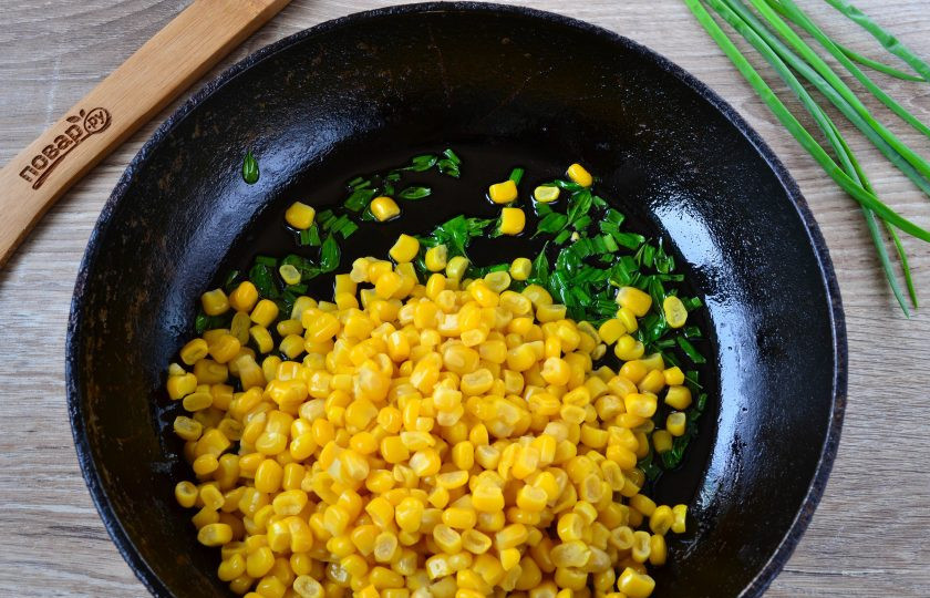 1. Этап. Фриттата с кукурузой и шпинатом: Зеленый лук мелко порубите и выложите на сковороду с разогретым растительным маслом вместе со шпинатом. Обжарьте несколько минут, добавьте консервированную кукурузу (жидкость нужно предварительно слить). Прогрейте кукурузу несколько минут.
