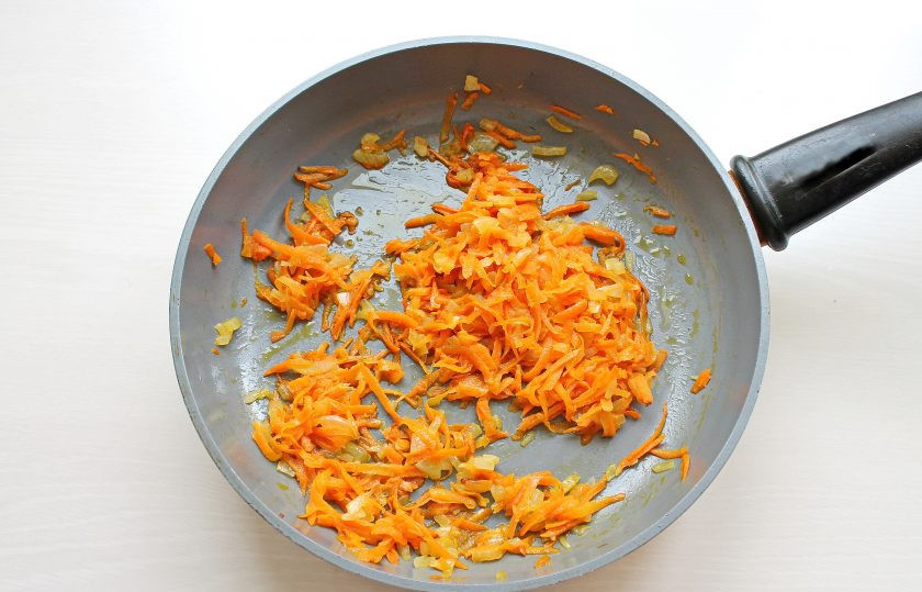 1. Этап. Украинский борщ с квашеной капустой: Лук и морковь почистите и вымойте. Лук мелко порежьте, морковь натрите на средней терке. В сковороду налейте растительное масло и разогрейте на среднем огне. Выложите подготовленные овощи и обжаривайте, перемешивая, в течение 5 минут.