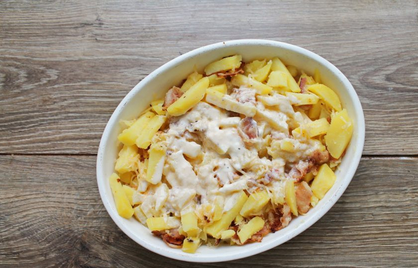 1. Этап. Картофель с беконом в сметанной заливке: Залейте верх сметанной заливкой и перемешайте.