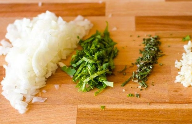 1. Этап. Куриные шарики в сливочном соусе с зеленым горошком: 2. Измельчите лук, пару зубчиков чеснока, зелень.