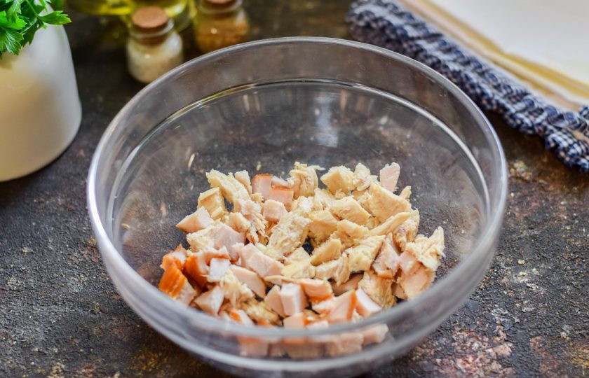 1. Этап. Салат Роза из огурцов: Куриное филе, вареное и копченое, нарежьте небольшими кубиками и переложите в салатник.