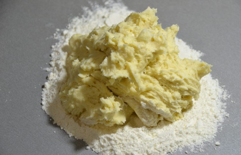 1. Этап. Пирог с зеленым луком и творогом: Выложите тесто на стол, присыпанный остатками муки и продолжайте вымешивать тесто руками.