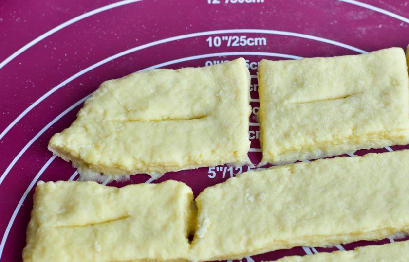 1. Этап. Хворост на кефире с водкой: В каждом прямоугольнике сделайте надрез в центре.