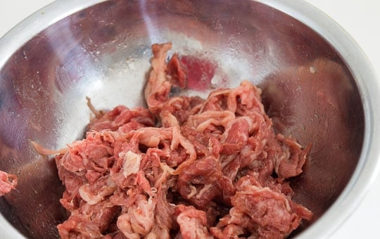 1. Этап. Брокколи и говядина: 1. Мякоть говядины нарежьте тонкими ломтиками. В миску налейте вино, соевый соус, 0,5 чайных ложки картофельного крахмала, поджаренное кунжутное масло и перемешайте, соедините смесь с мясом.