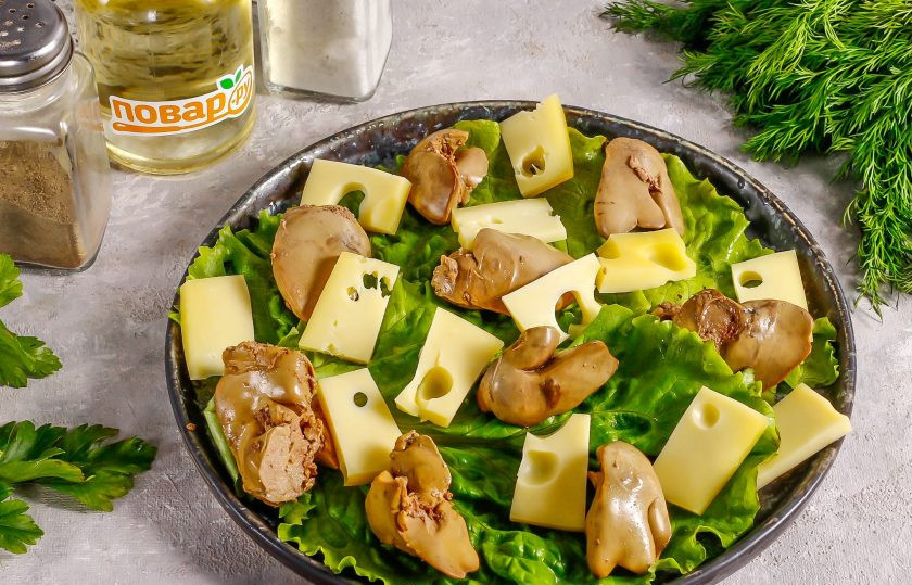 1. Этап. Теплый салат с куриной печенью и вишней: Нарежьте твердый сыр ломтиками и выложите на тарелку в любом порядке.