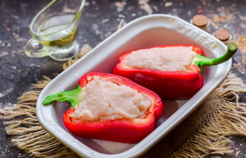 1. Этап. Перцы фаршированные куриной грудкой в духовке: Болгарский перец разрежьте пополам, наполните фаршем. Фарш предварительно сдобрите солью, перцем и специями.