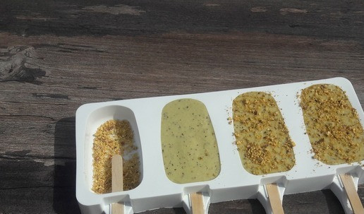 1. Этап. Эскимо на палочке-мороженое ПП: Формочки обсыпать рублеными фисташками. Готовую смесь разложить ложкой по формочкам на половину. Вставить в каждую ячейку палочку, залить еще мороженым. Сверху обсыпать фисташками, и отправить в морозилку минимум на шесть часов.