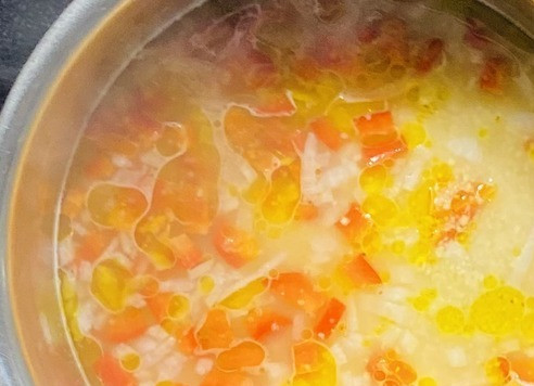 1. Этап. Кускус По-австралийски: Добавить кускус, мелко нарезанный болгарский перец, оливковое масло. Накрыть крышкой, снять с огня, оставить на 5-7 минут пока кускус не впитает жидкость и не станет мягким