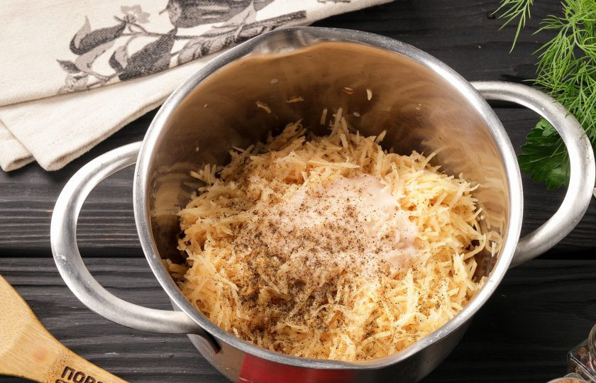 1. Этап. Колдуны с грибами: Слейте жидкость из миски, а оставшийся на дне картофельный крахмал отправьте назад в миску с натёртым картофелем. Добавьте соль, перец и перемешайте.